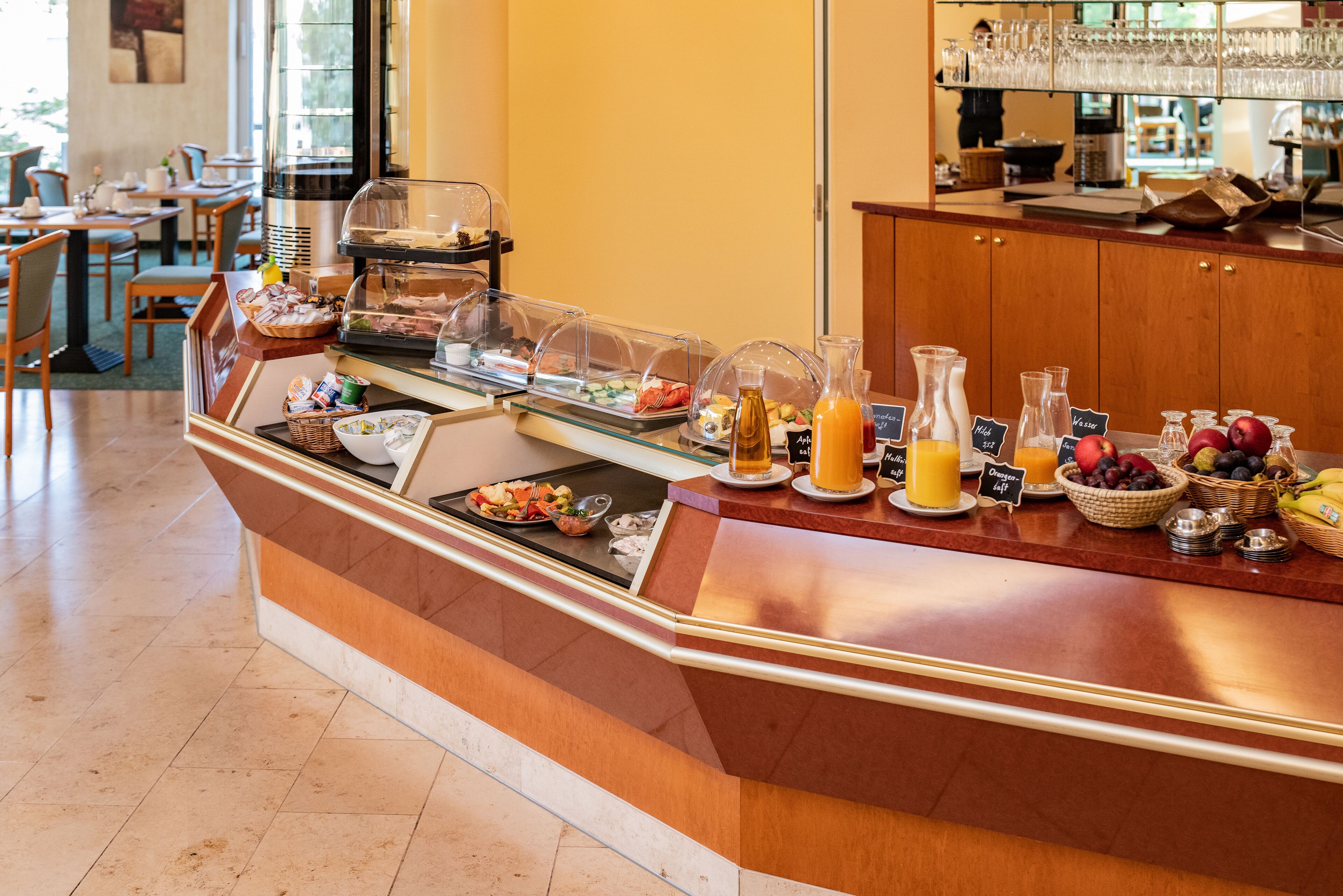 A breakfast buffet with various food items, beverages, and a coffee station.