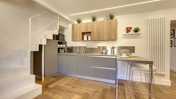 Apartamento, 2 quartos | Cozinha americana privada | Geladeira grande, micro-ondas, cooktop, lava-louças