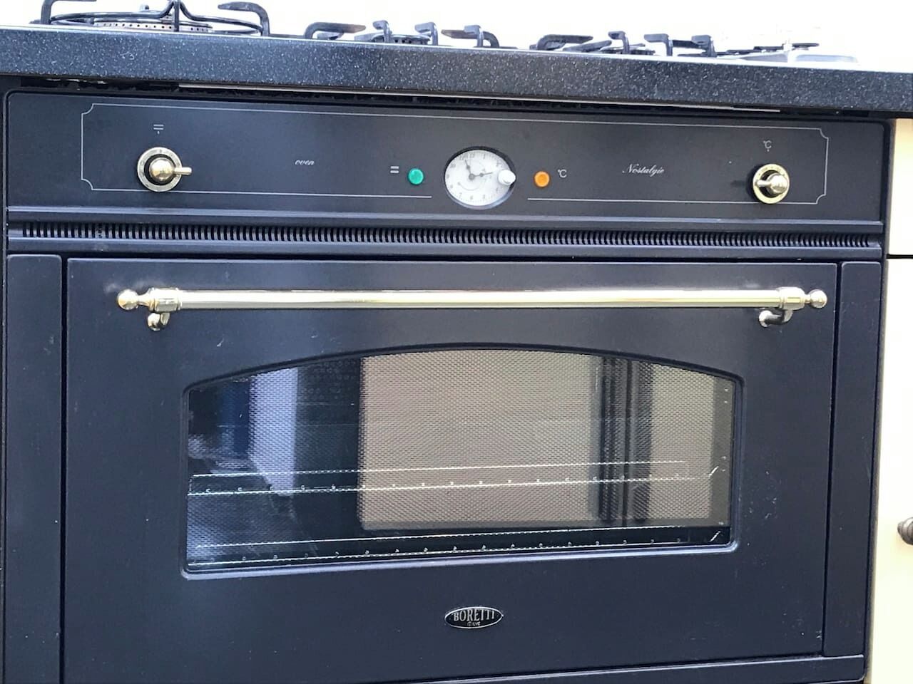A black oven with a glass door, a control panel with a clock, and a brand name 'Boretti' on the front.