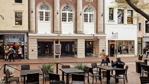 A building named "The Jefferson" with a classical architectural style, featuring columns and arched windows.