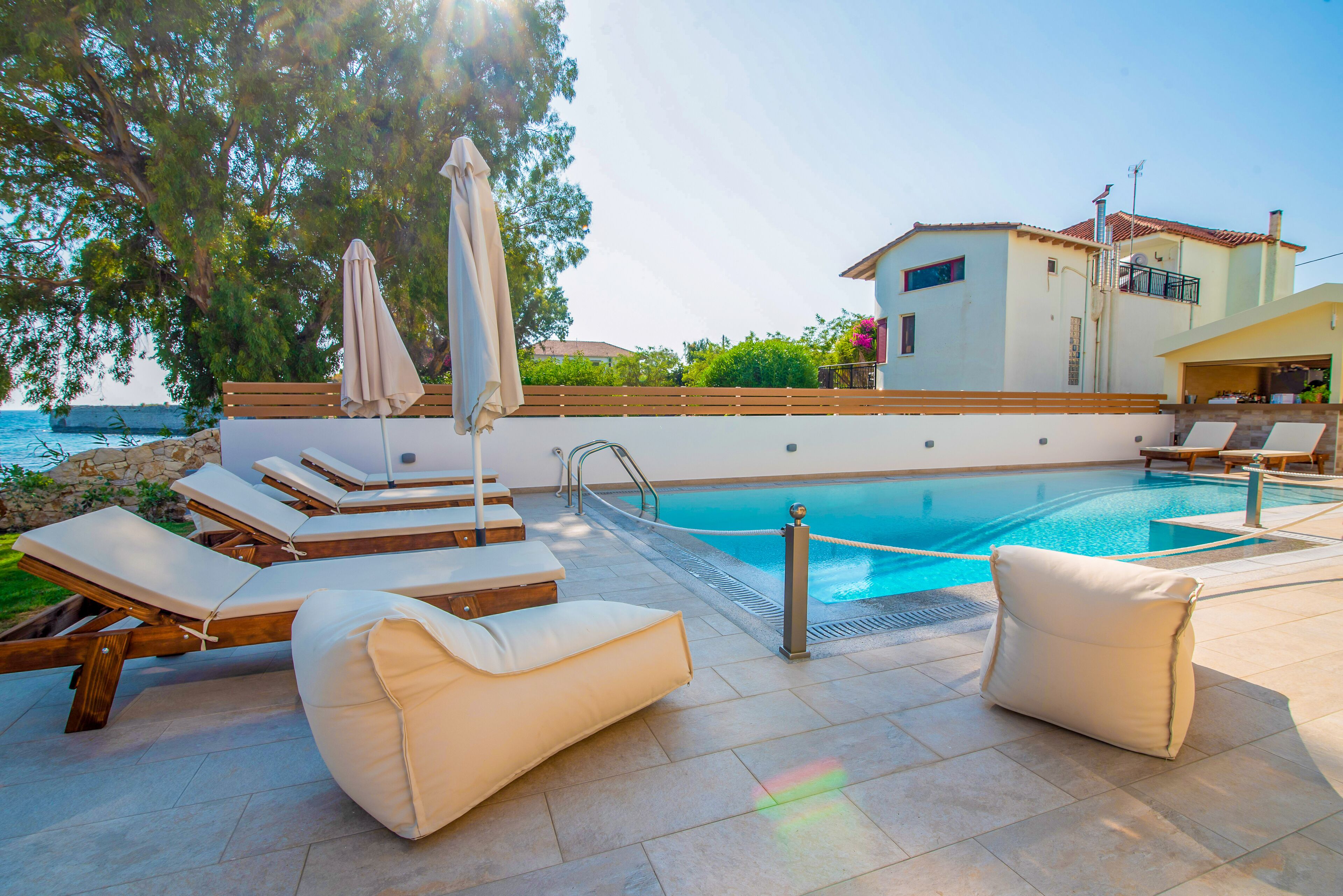A poolside area with lounge chairs and a pool.