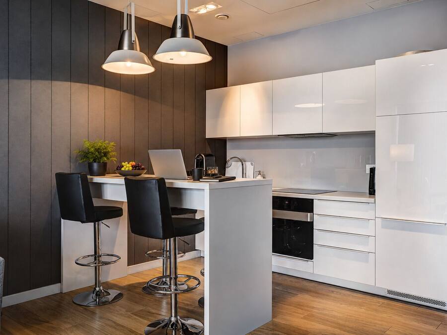 A modern kitchen with white cabinets, a central island with bar stools, and pendant lighting.