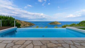 A swimming pool with a view of the sea and two islands. - Coastal Paradise Found - Komis' Private Pool Gem (Agios Nikolaos)
