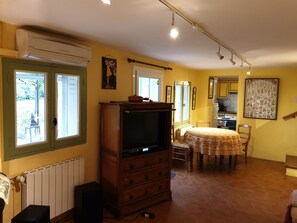 Relax in this inviting living room with a dining table, TV, and comfortable seating area.