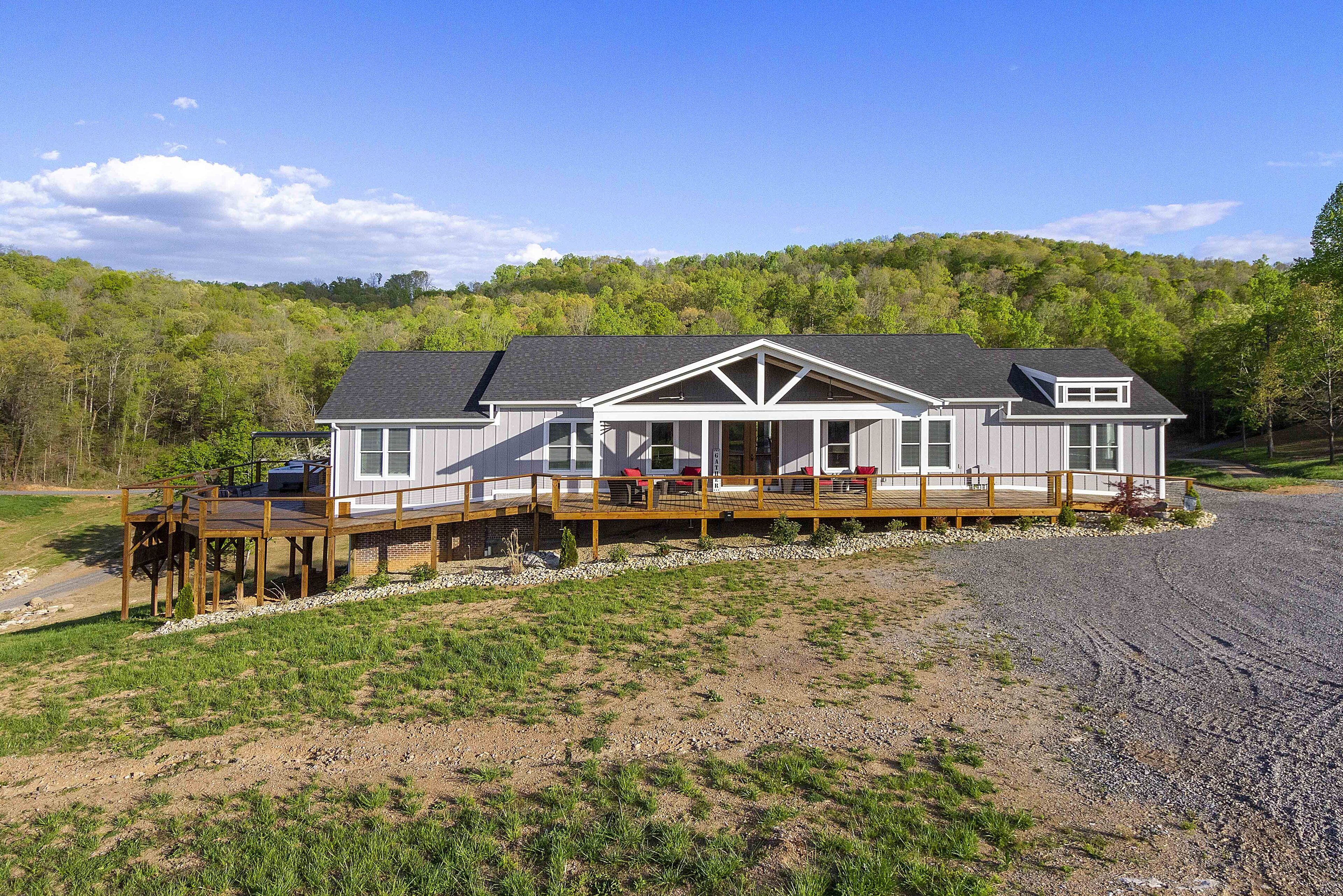 A two-story house with a covered porch and a deck.
