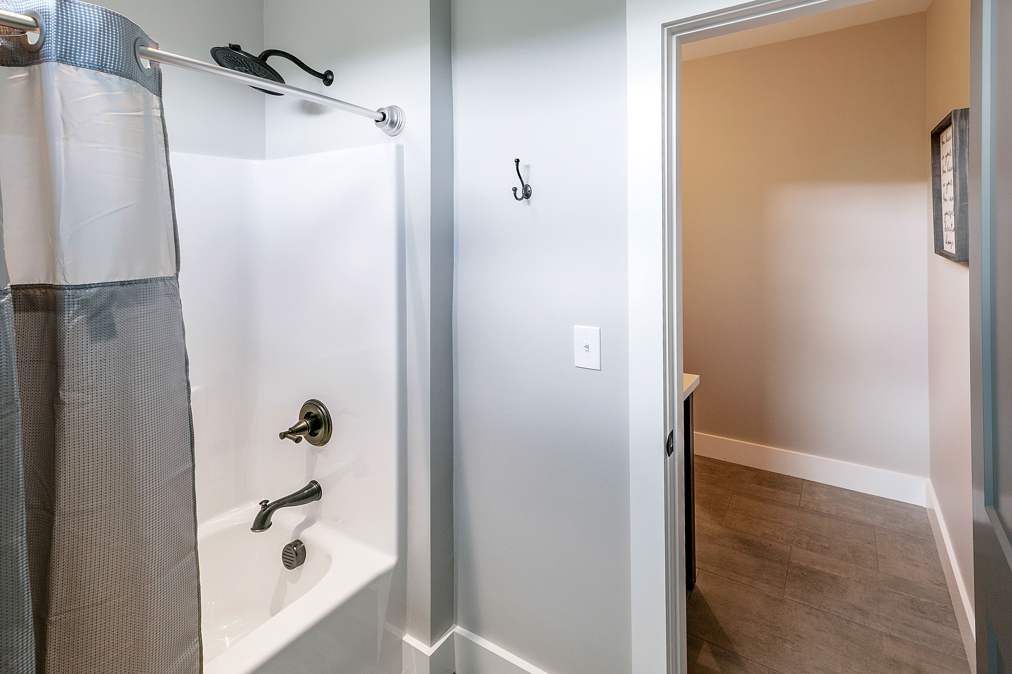 A bathroom with a shower, a bathtub, and a toilet.