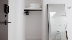 A modern bathroom with a white sink, a mirror, and a towel rack. - Boutique Hotel Room above The Jefferson Theater on the Downtown Mall (Charlottesville)