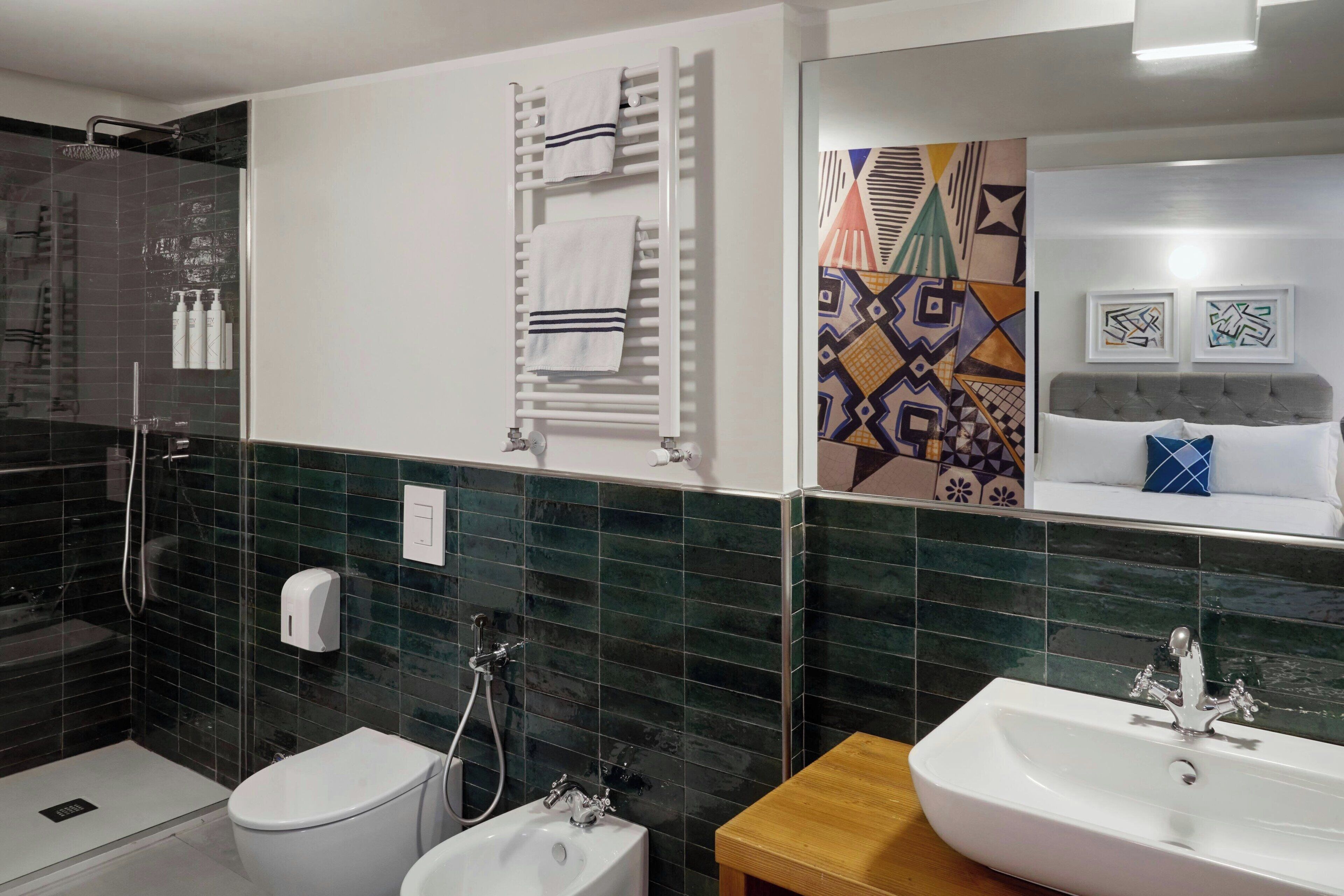 deluxe room, 1 queen bed | bathroom | shower, free toiletries, hair dryer, slippers