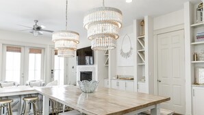 A spacious kitchen with a wooden island, pendant lights, and white cabinetry. - Private Pool | Walk to Rosemary Beach (Panama City Beach)