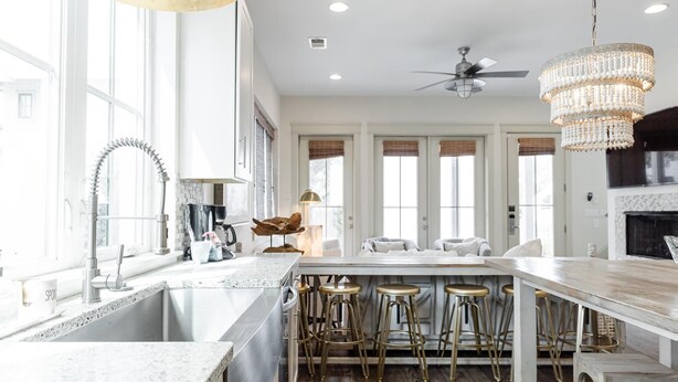 A spacious kitchen with a large island, bar stools, and a chandelier. - Private Pool | Walk to Rosemary Beach (Panama City Beach)