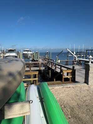 A marina with boats docked, wooden walkways, and a clear blue sky. - PIRATES PARADISE---Quiet Gulf Front  Property near Clearwater/Tarpon Springs!! (New Port Richey)