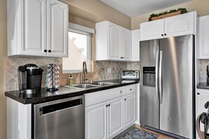 Enjoy cooking in this well-equipped kitchen with a dishwasher, refrigerator, oven, coffee maker, and toaster oven.