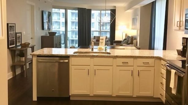 A modern kitchen with a central island, built-in cabinets, and a dishwasher. - OCEAN FRONT, PRIVATE BEACH Luxury Suite with Balcony sleeping 8 adults (Hilton Head Island)