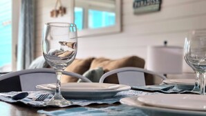 A dining table set with plates, cutlery, and a glass of water.