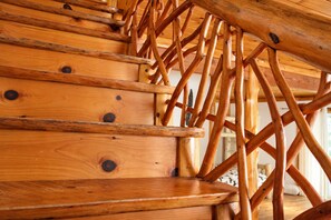 A wooden staircase with a unique crisscross design. - Unique Rustic Ski/Tree House - Game room, Hot tub & Sauna (Jay)