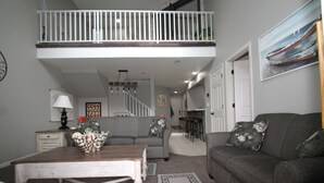 A living room with a grey sofa, a wooden coffee table, and a patterned rug. - Parkview Bay, 3 bed, 3 bath, lakeview, elevator, wifi, pool (Osage Beach)