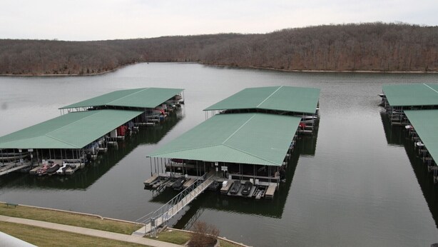 A marina with multiple docks, each featuring a green roof and equipped with boats. - Parkview Bay, 3 bed, 3 bath, lakeview, elevator, wifi, pool (Osage Beach)