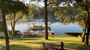 A serene lakeside park with a dock, picnic tables, and a statue. - Home on Hot Springs beautiful Lake Hamilton. TWO MASTER SUITES!!  (Hot Springs)