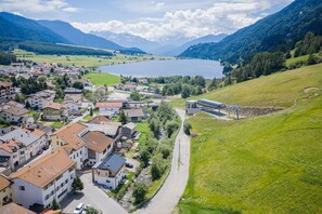 A town with a lake, mountains, and a train station.