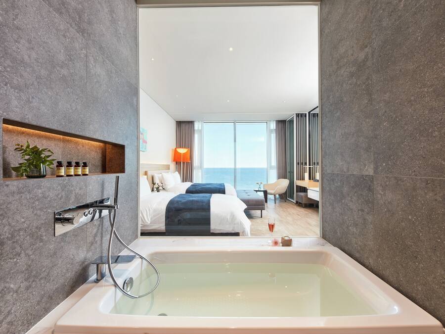 A modern bathroom with a large bathtub, a shower, and a glass-enclosed shower area.