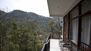 A balcony with a view of a forested hillside. - Corbett Riviera (Lansdowne)