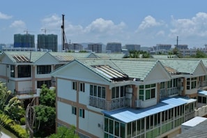 A row of modern buildings with flat roofs, large windows, and balconies. - Jinjiang Inn Select (Sanyawan Jinjiling) (Sanya)