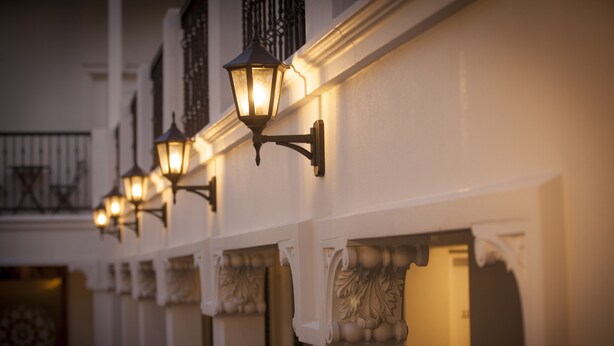A row of wall-mounted lights along a building's exterior.