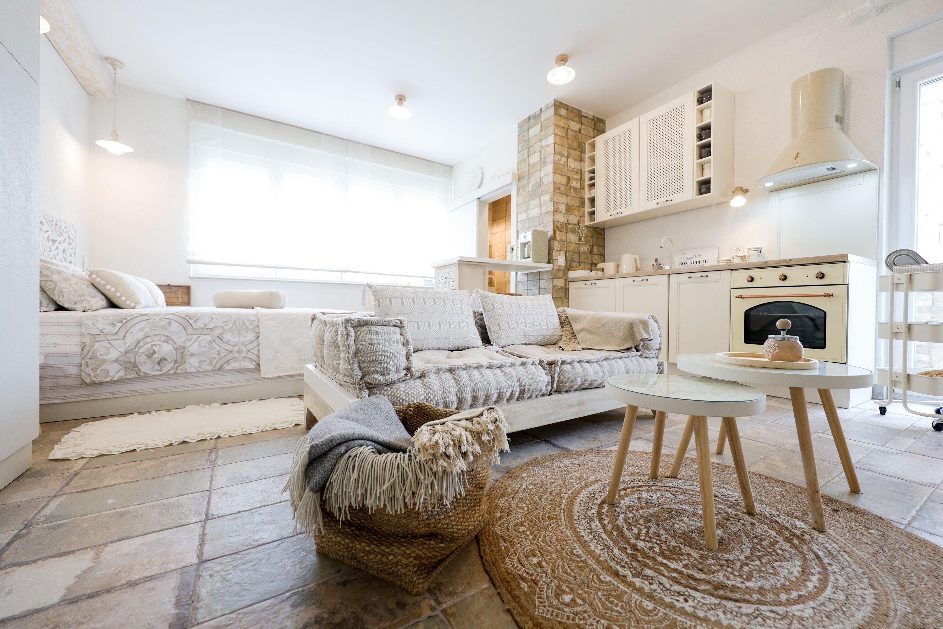 A modern living room with a sofa, a coffee table, and a fireplace.