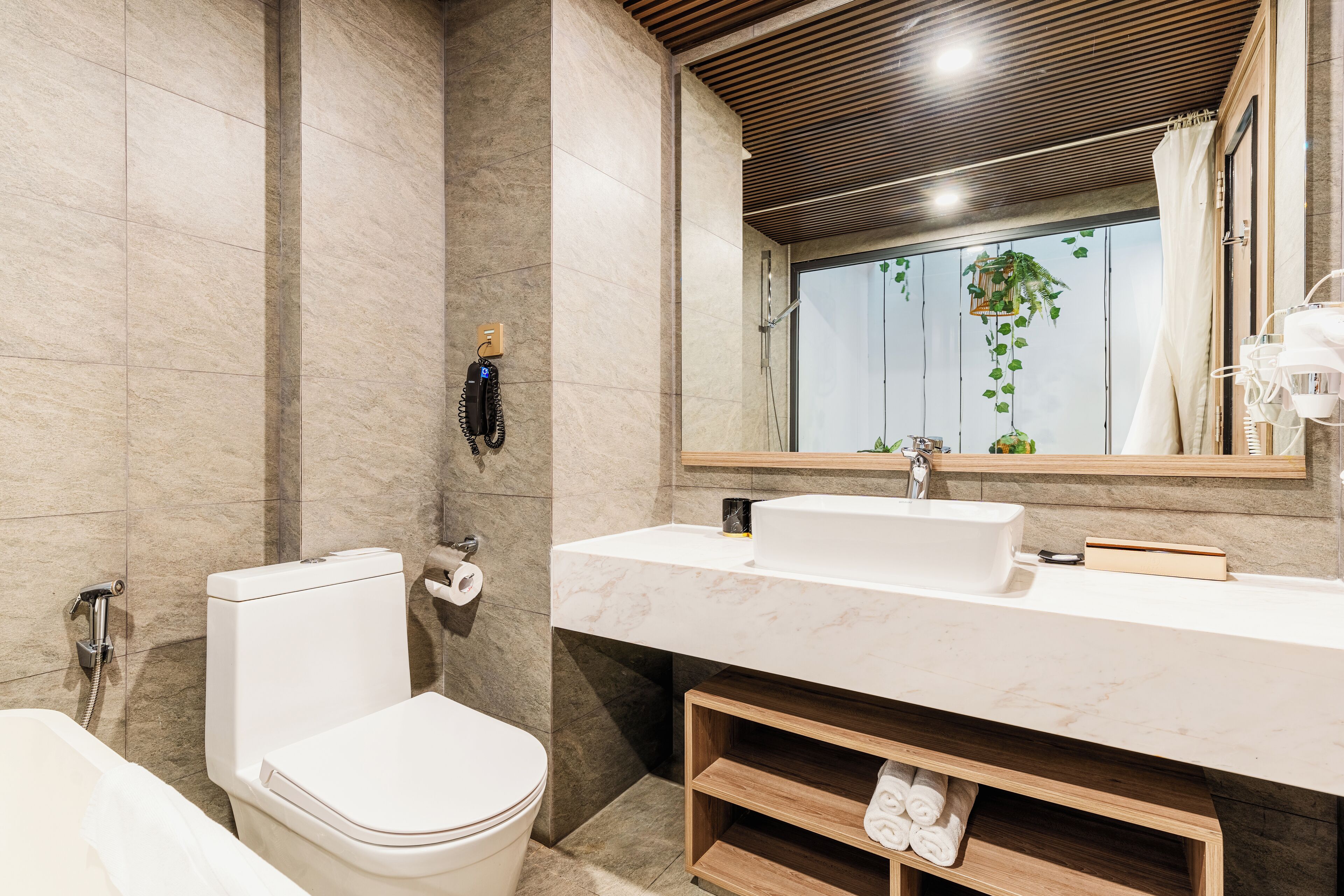 A modern bathroom with a toilet, bidet, and sink.