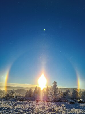 A snowy landscape with a clear sky and a visible rainbow. - Vauldalen Fjellhotell (Roros)