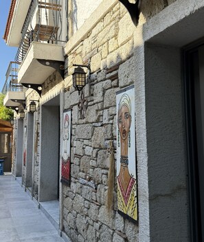 Un edificio de piedra con balcones, suelo de baldosas y adornos en las paredes.