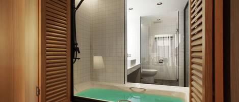 A modern bathroom with a bathtub, a shower, and a toilet.