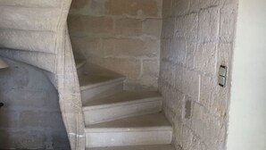 A stone staircase with a light fixture at the top. - Mas provençal en pierre  (UZES)