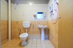 A small bathroom with a toilet, sink, and shower. - D'Jawi Bella Hotel (Sungai Jawi)