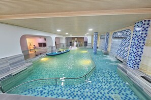 An indoor swimming pool with clear water, a ladder, and a lifeguard chair. - Tuyet Lan Hotel Vung Tau (Ho Chi Minh City)