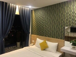 A hotel room with a bed, a nightstand, a TV, and a window with curtains. - My House 2 (Xuan Huong - Da Lat)