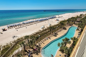 A beach resort with a swimming pool, beach umbrellas, and a pier in the background. - Calypso Resort by BBG (Panama City Beach)