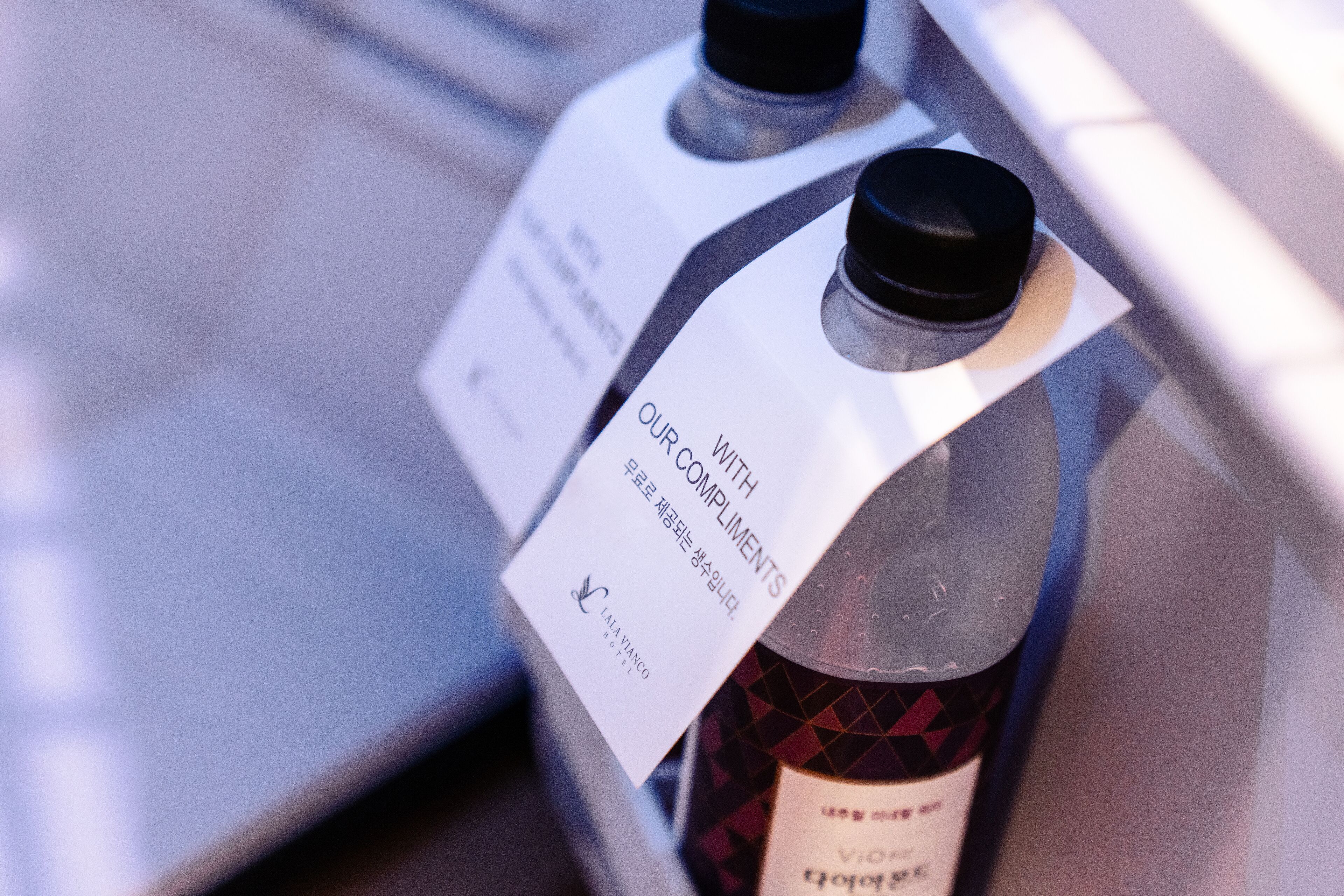 A bottle with a label that reads "OUR WITH COMPLIMENTS" and "LALAVANGO".