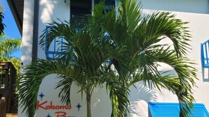 A building with a white exterior and blue shutters, labeled "Kokomo Bay". - Escape to Kokomo Bay,  Escape to Paradise (Fort Myers)