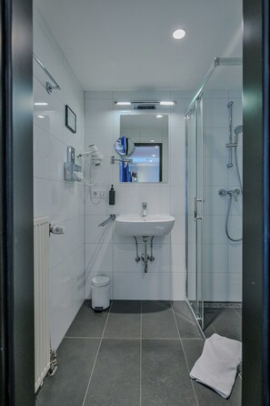 Shower, hair dryer, slippers, towels