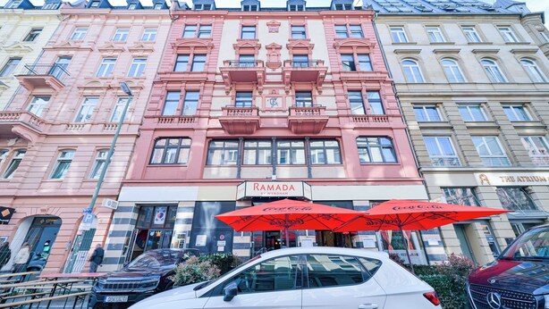 A multi-story building with a prominent 'RAMADA' sign, featuring a classic architectural style with ornate balconies and large windows. - Ramada by Wyndham Frankfurt Central Station (Frankfurt)