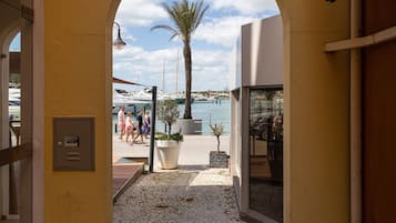 Entrada a un edificio con vistas a un puerto deportivo y barcos.