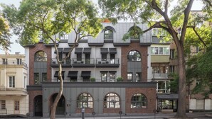 A multi-story building with a brick facade, large arched windows, and a balcony. - BRYK Hotel (Odesa)