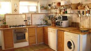 A compact kitchen with a gas stove, oven, microwave, sink, and built-in washing machine. - Typical dwelling with garden & sea view on the Bay  (Scalea)