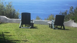 Two Adirondack chairs facing a scenic view of the ocean. - Typical dwelling with garden & sea view on the Bay  (Scalea)
