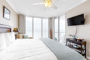 Relax in this inviting room with a large bed, ceiling fan, and flat-screen TV, plus a desk and window with a view.