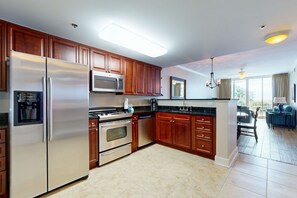 Enjoy cooking in this well-equipped kitchen with a refrigerator, microwave, oven, and dishwasher.