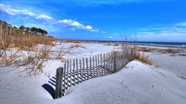 A sandy beach with a wooden fence and a clear blue sky. - Newly Renovated Hilton Head Resort Beach Condo - 2 Bedroom - Private Balcony (Hilton Head Island)