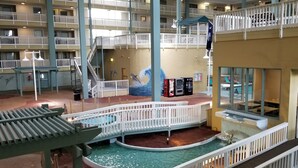 A multi-level indoor atrium with a central water feature, railings, and a mural of dolphins. - Newly Renovated Hilton Head Resort Beach Condo - 2 Bedroom - Private Balcony (Hilton Head Island)