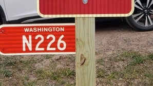 A red sign for the Piece of Paradise River House, located at N226 Bear Paw Rd, with a contact number (505) 944-6227. - Piece of Paradise / Private Hot Tub (Holcombe)
